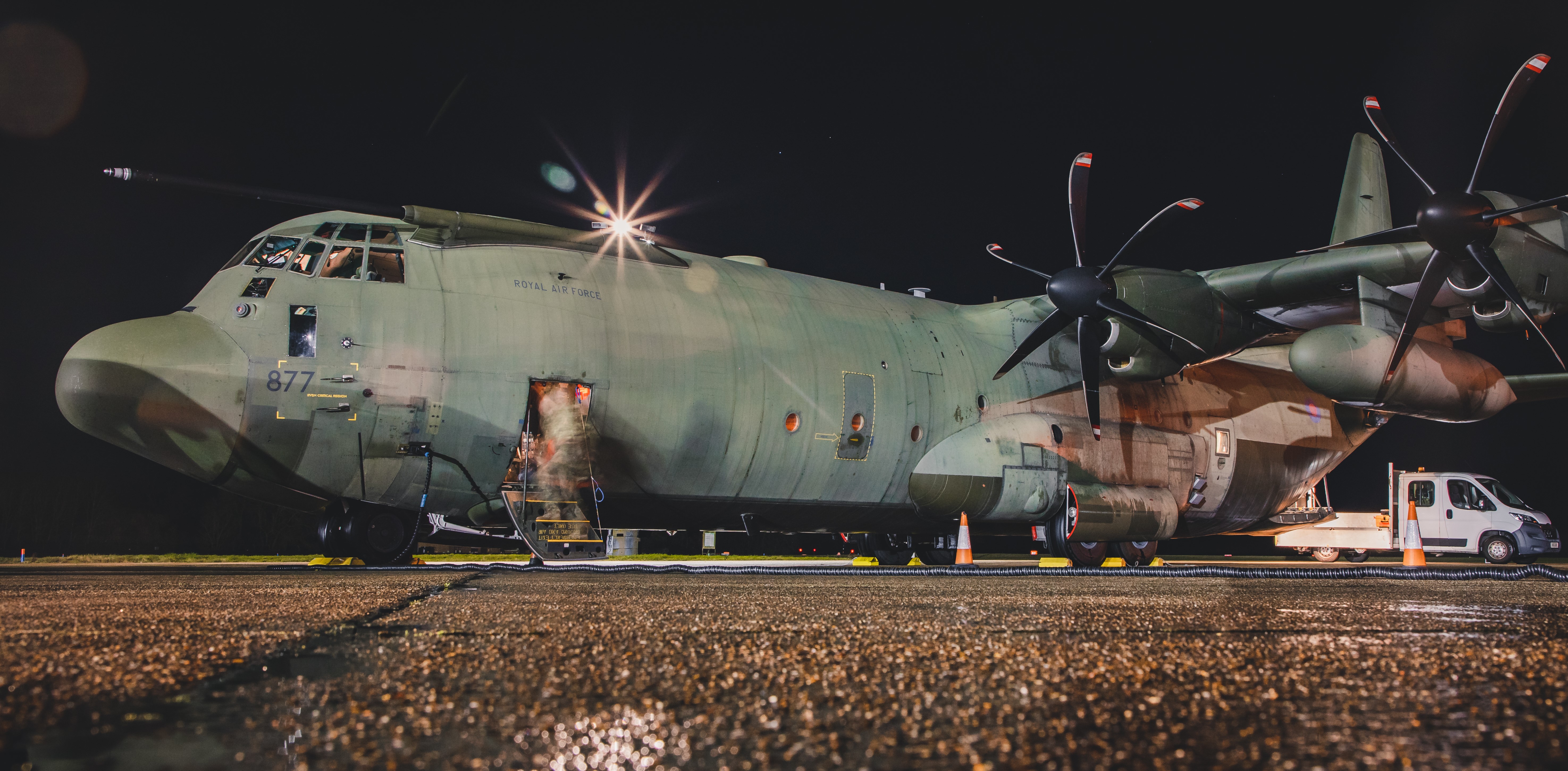 Image shows the RAF Hercules aircraft parking on the airfield at night.